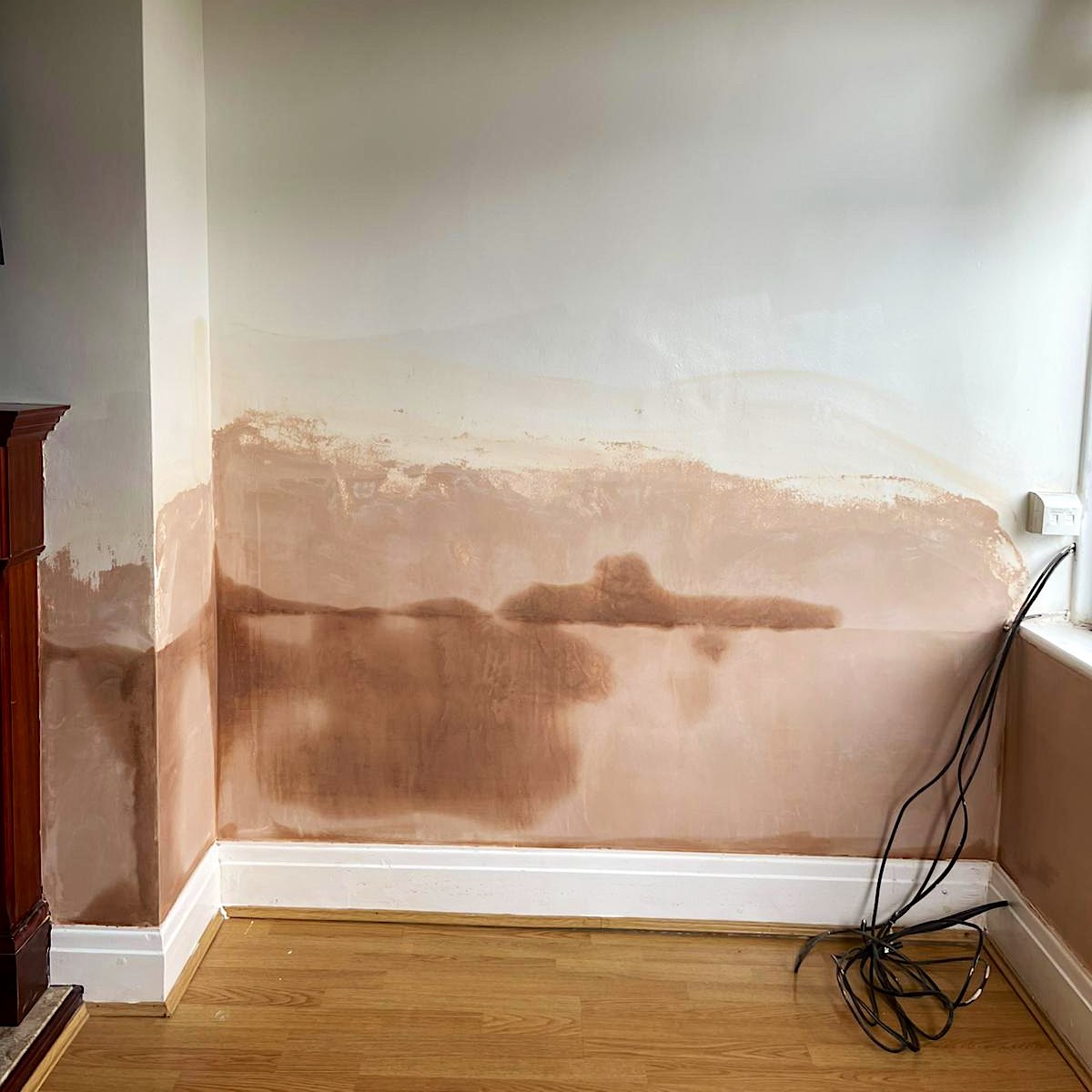 New plaster drying out along the lower part of a wall beside a fireplace in Doncaster