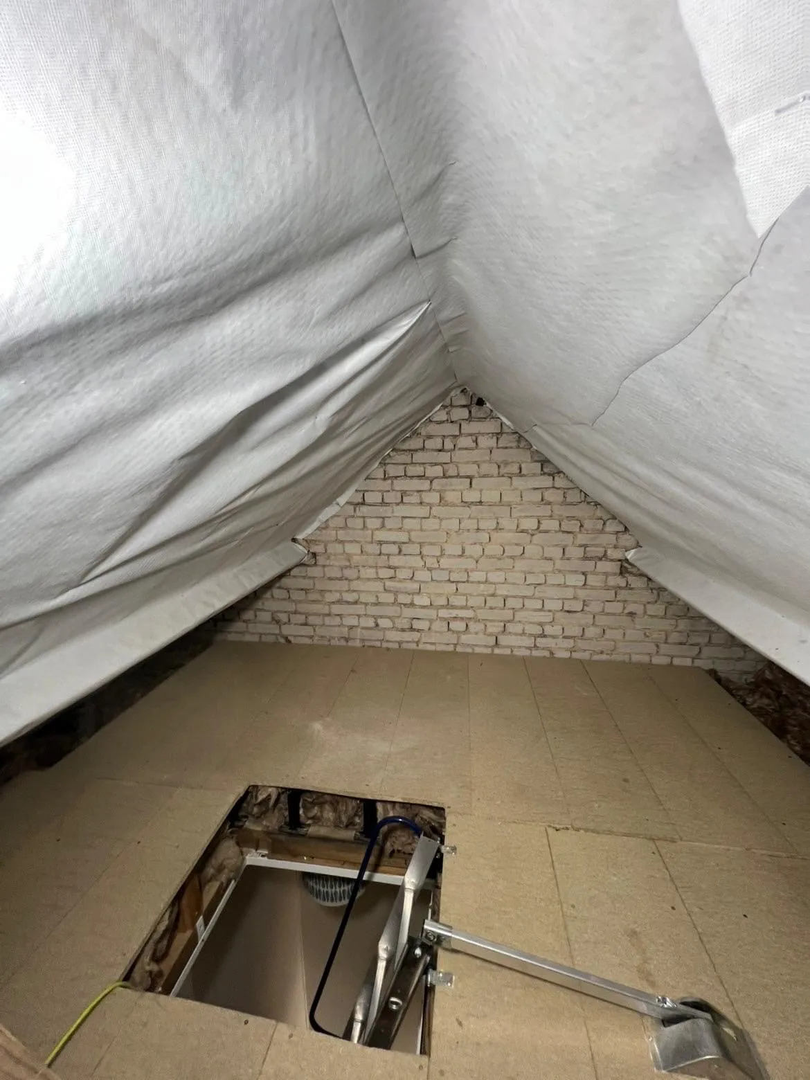 Finished raised loft boarding with a white membrane under the roof in a Lancing loft