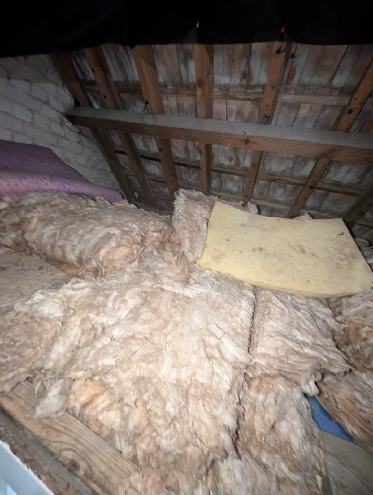 Loose old insulation and debris in a Lancing loft before removal and loft boarding