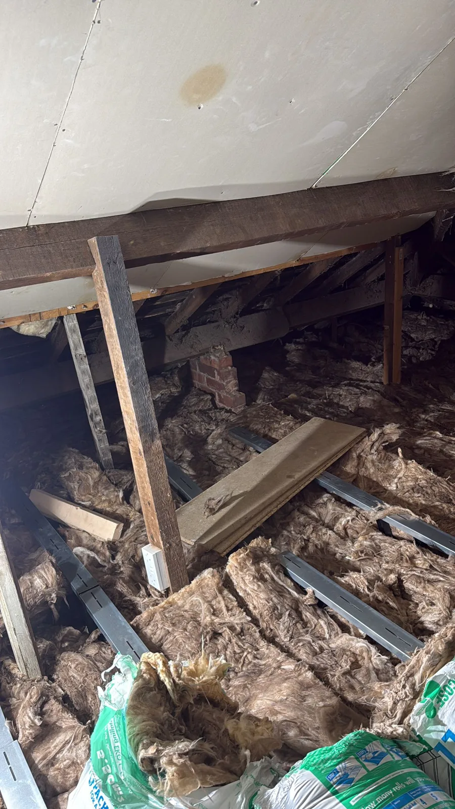 Mineral wool loft insulation laid around the timbers of an Aldridge loft