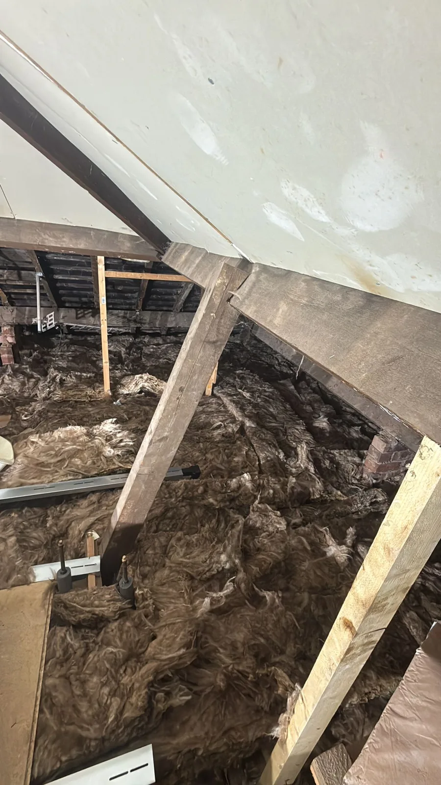 New mineral wool loft insulation laid across the joists of a loft in Aldridge, Walsall