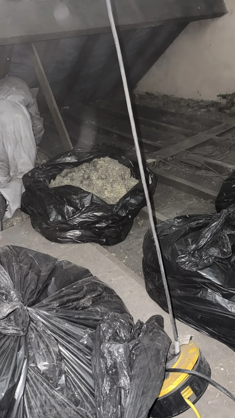 Old loft insulation bagged up for removal from a Chesterfield loft