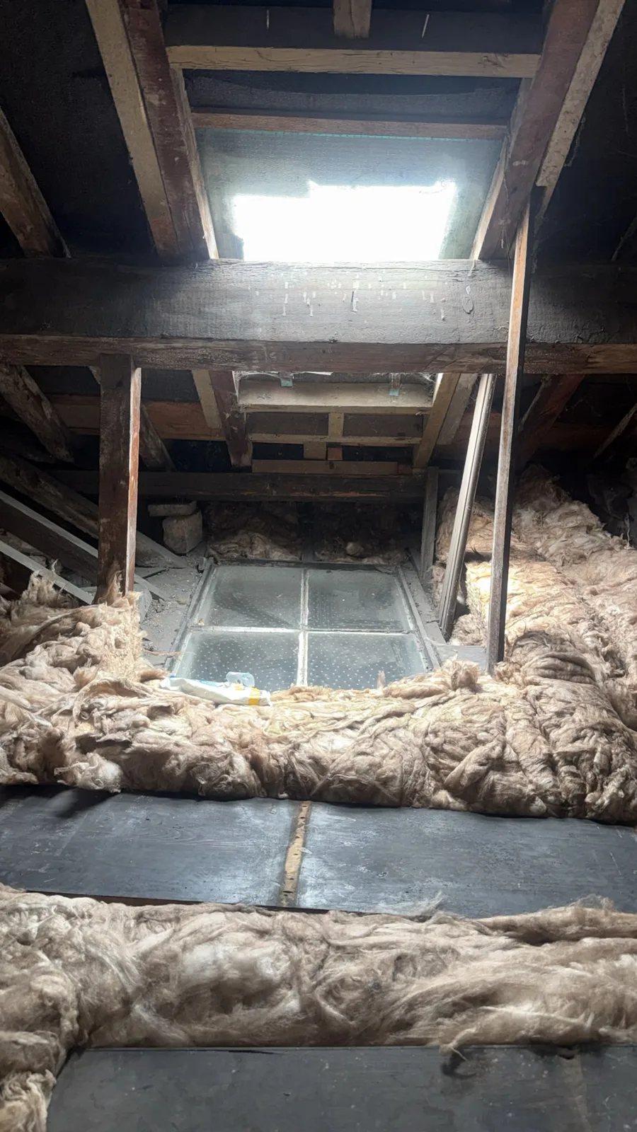 New loft insulation laid around the glazed panel in a Denbigh loft
