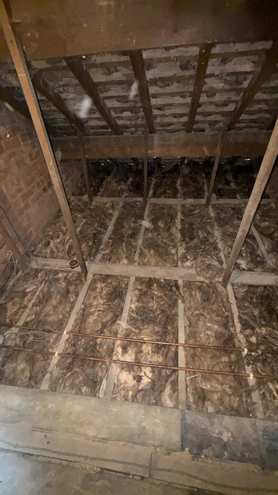 First layer of mineral wool laid between the joists in a Garstang loft