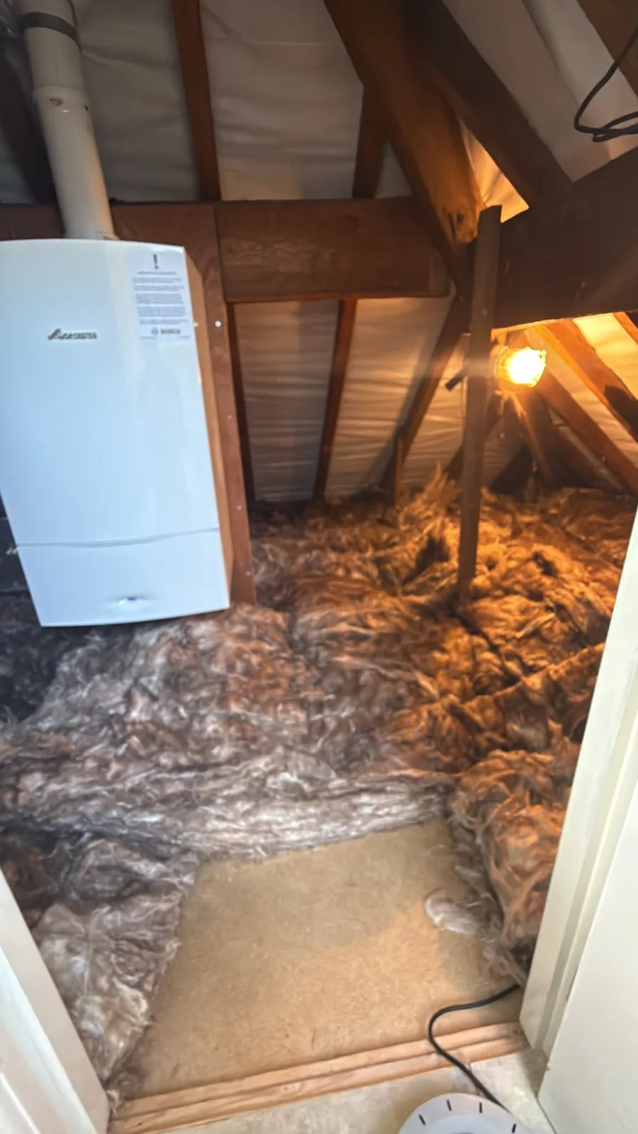 Heswall loft near the hatch with new loft insulation across the floor