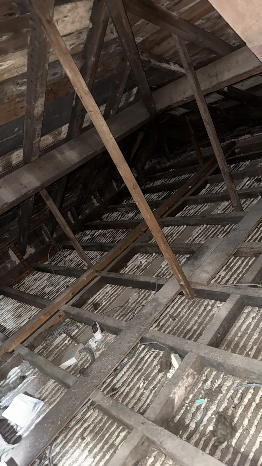 Bare joists across a large Macclesfield loft after the old insulation was removed