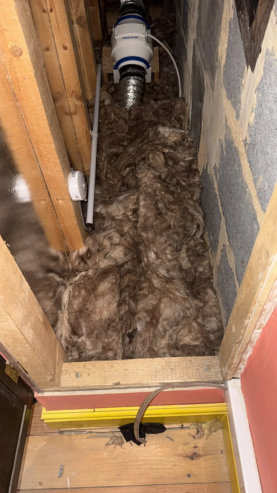 Finished loft insulation behind an access hatch in a Morley home