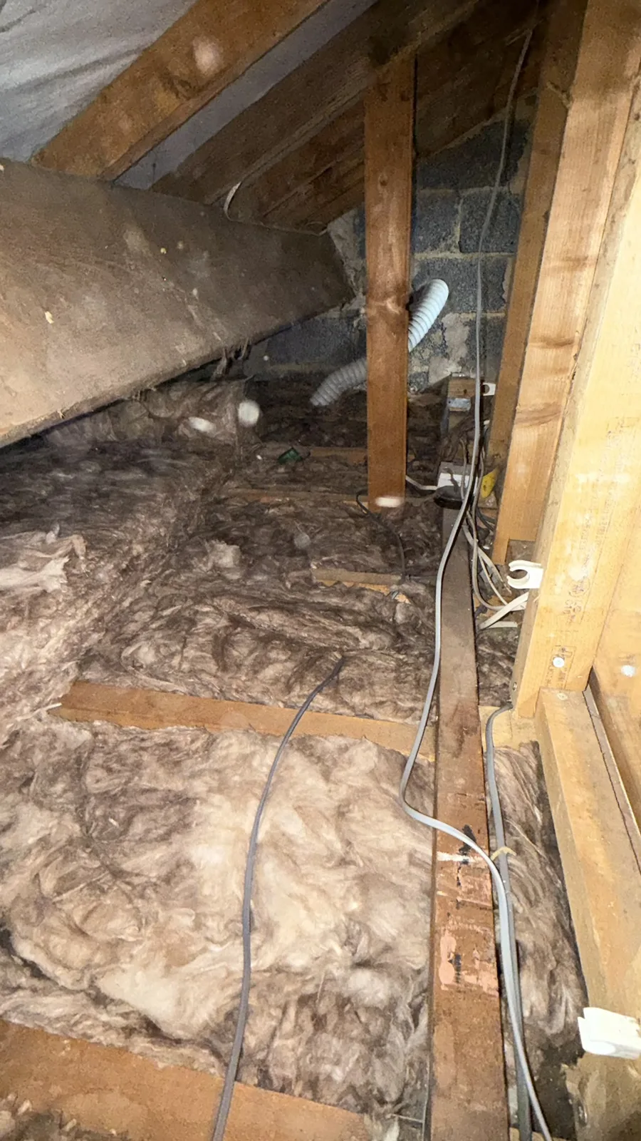 Mineral wool loft insulation laid along an eaves space in Tingley, Morley