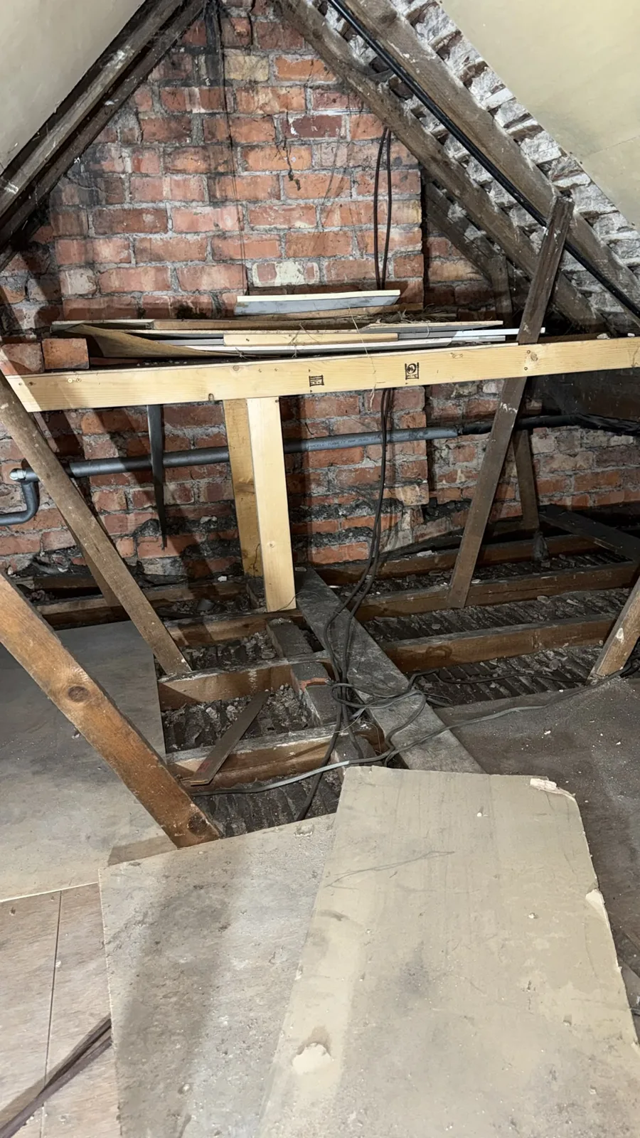 Cuddington, Northwich loft before work with old boards and thin insulation between the joists