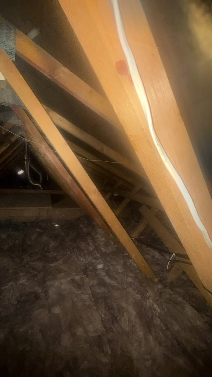 Finished Rhyl loft with thick mineral wool loft insulation covering the joists