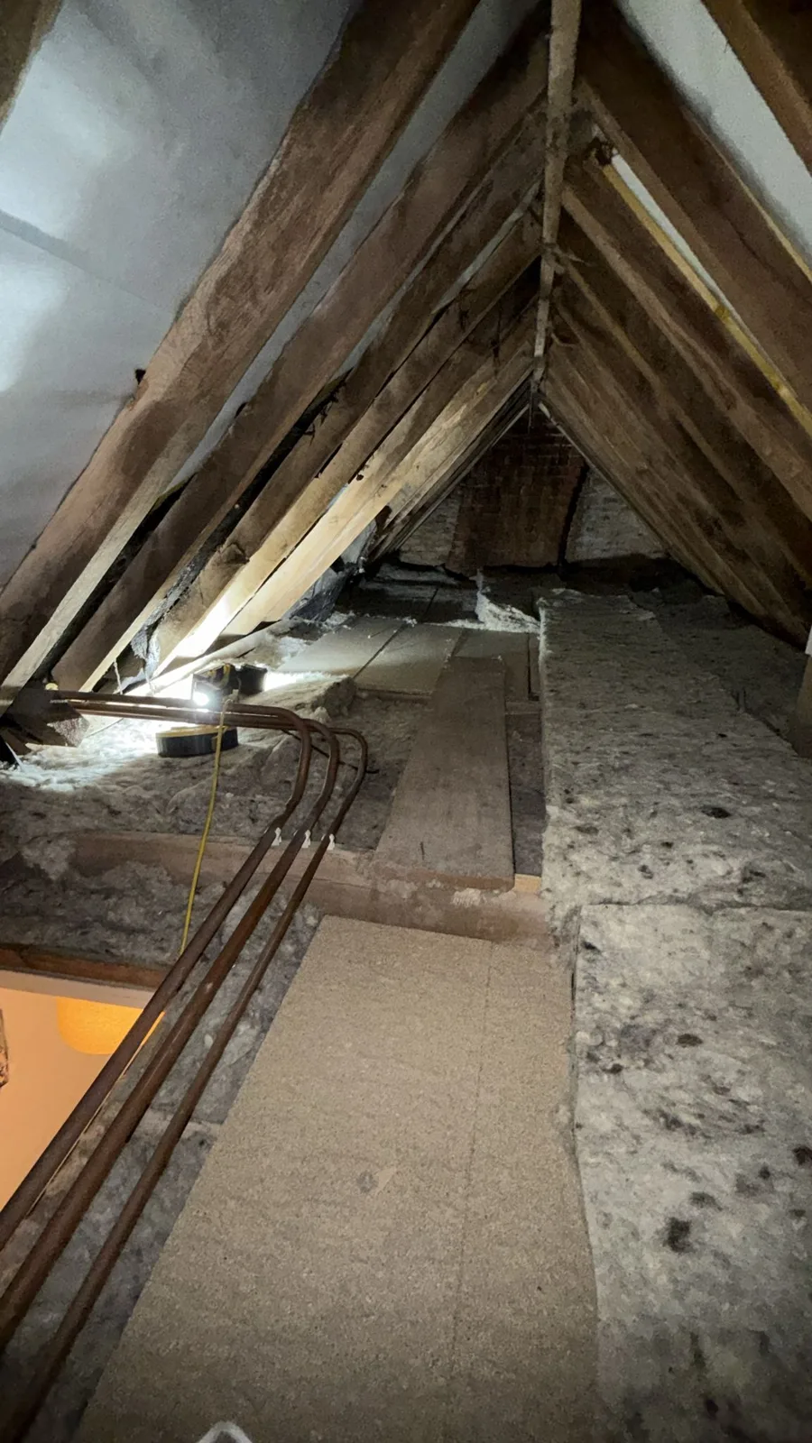 Boarded walkway laid through a Sleaford area loft between new loft insulation