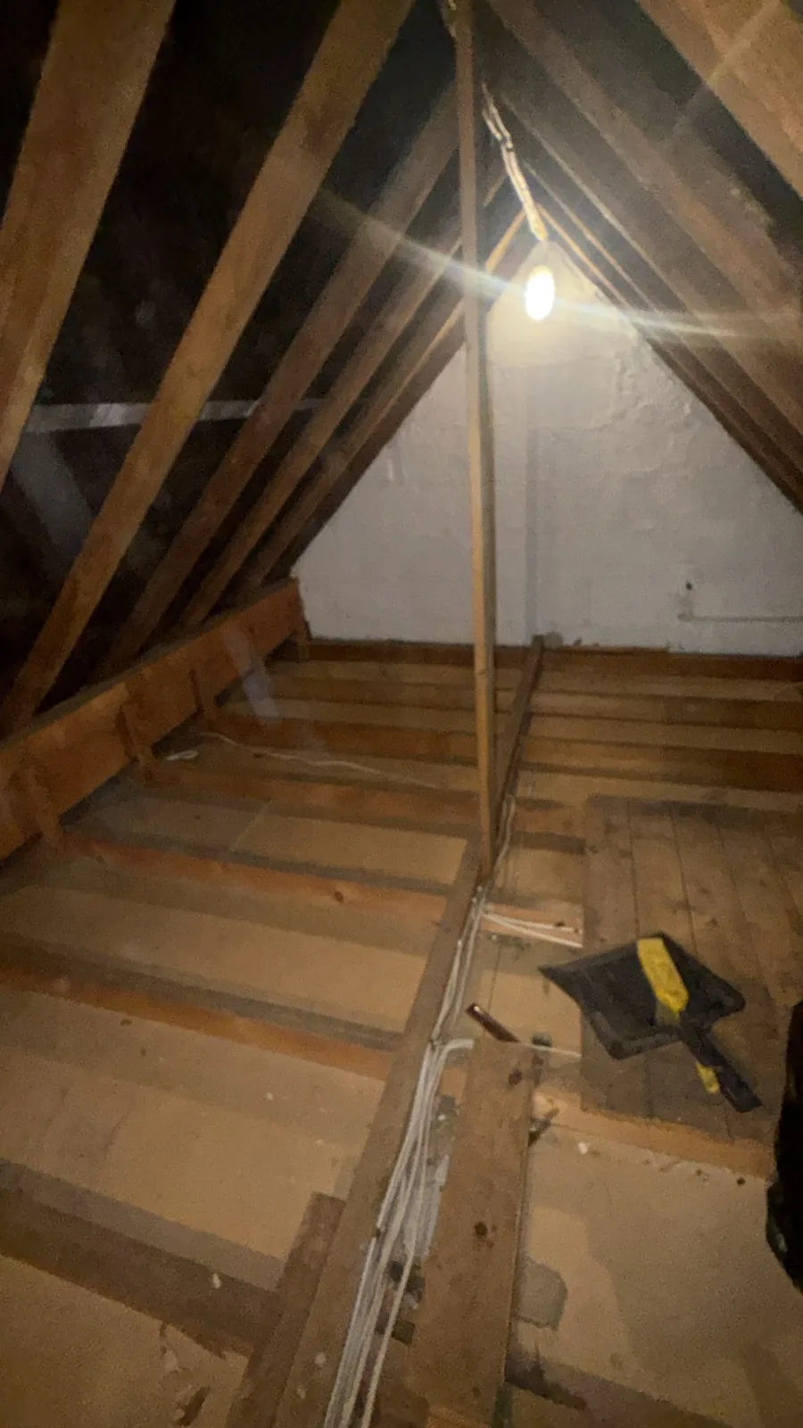 Tadcaster loft with old boards lifted, showing the joists before new loft insulation