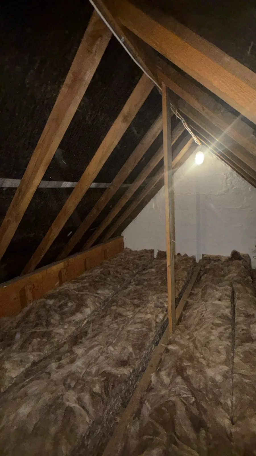 Finished Tadcaster loft with new mineral wool loft insulation laid between and over the joists