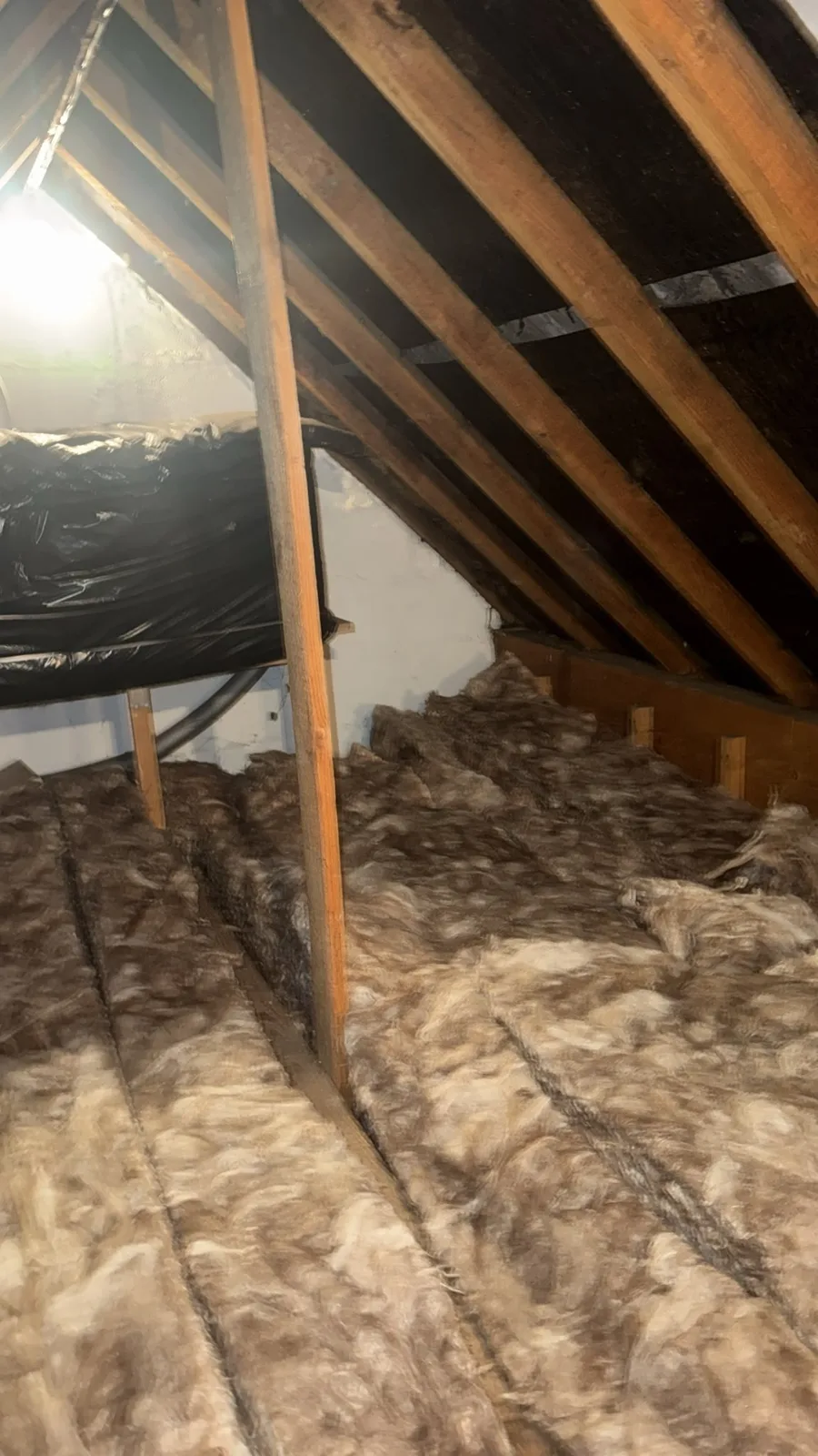 Thick new loft insulation running the length of a loft in Stutton, Tadcaster