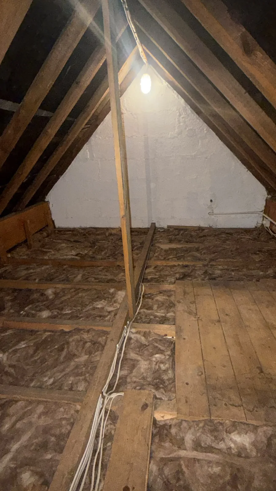 Tadcaster loft part way through, with new mineral wool loft insulation going in as old boards come up