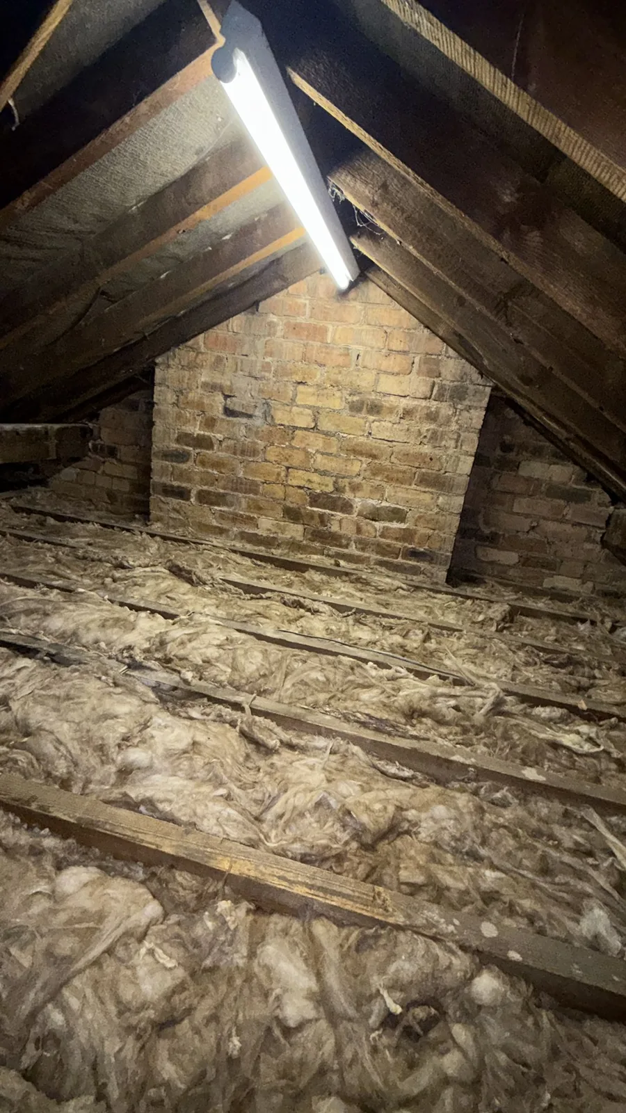 Walsall loft before new loft insulation, with old insulation between the joists