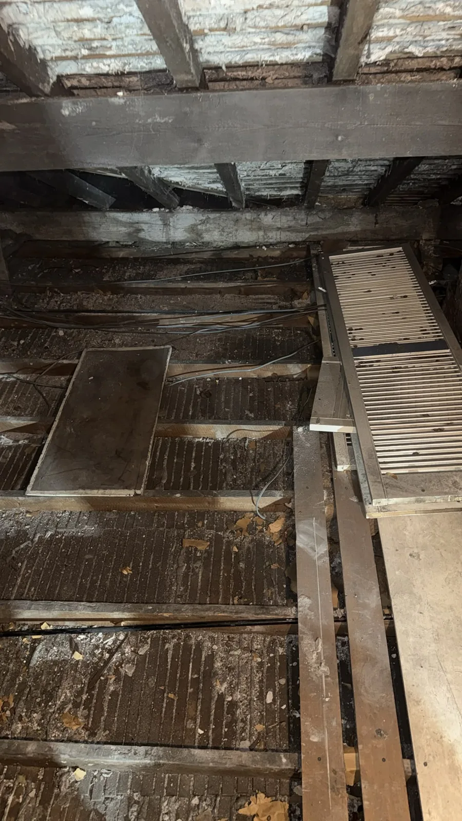 Old boards being lifted from the joists during loft clearance in Warrington