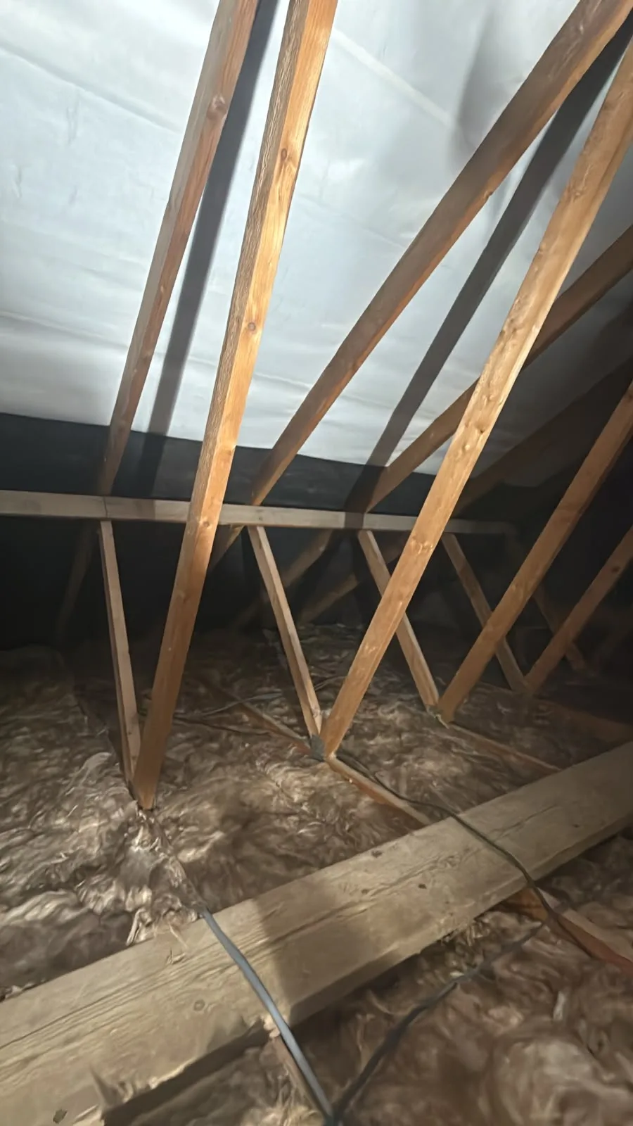 Loft insulation going down between the joists during the job in Worcester