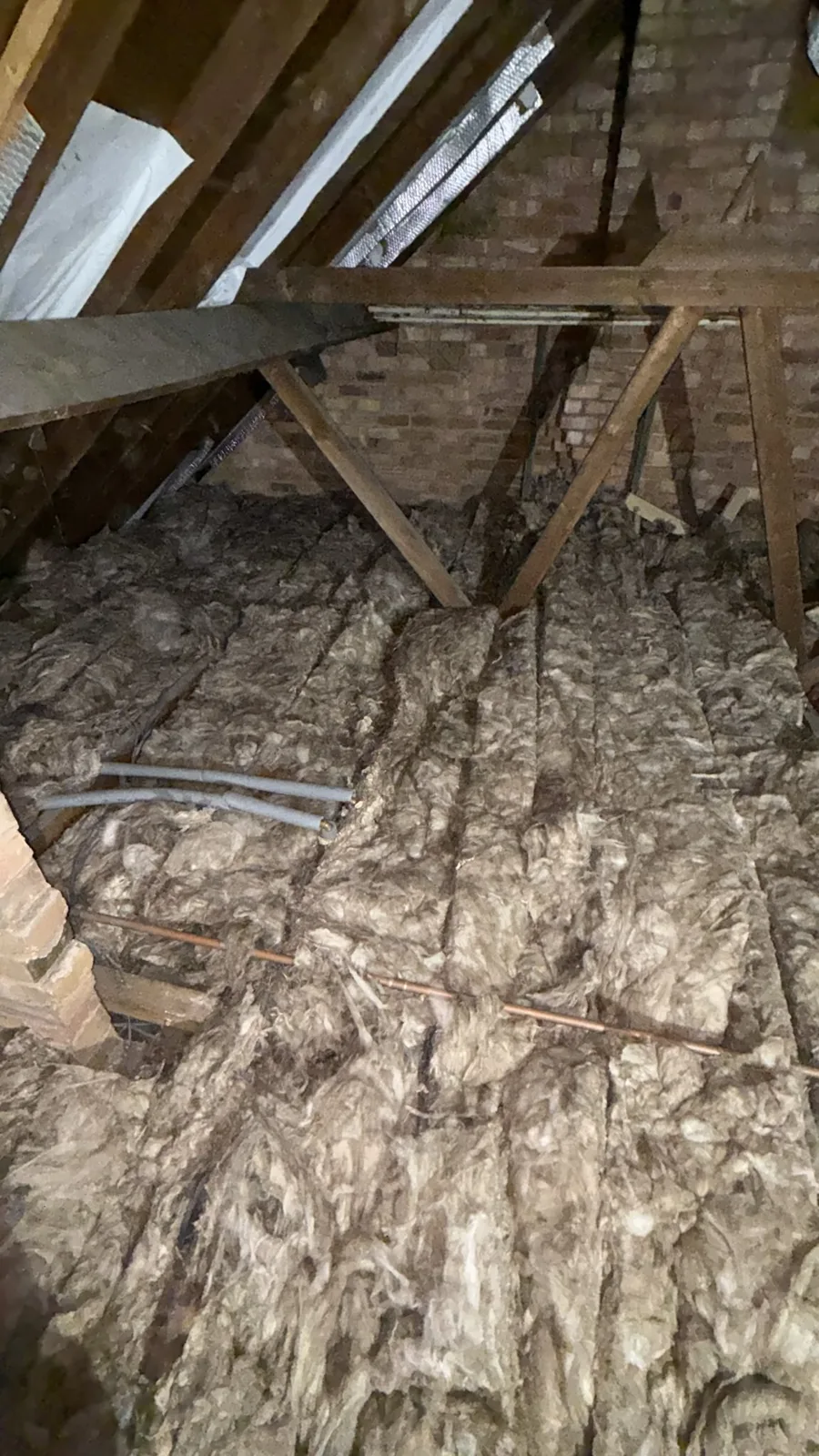 New 300mm mineral wool loft insulation laid in rows across a Worksop loft