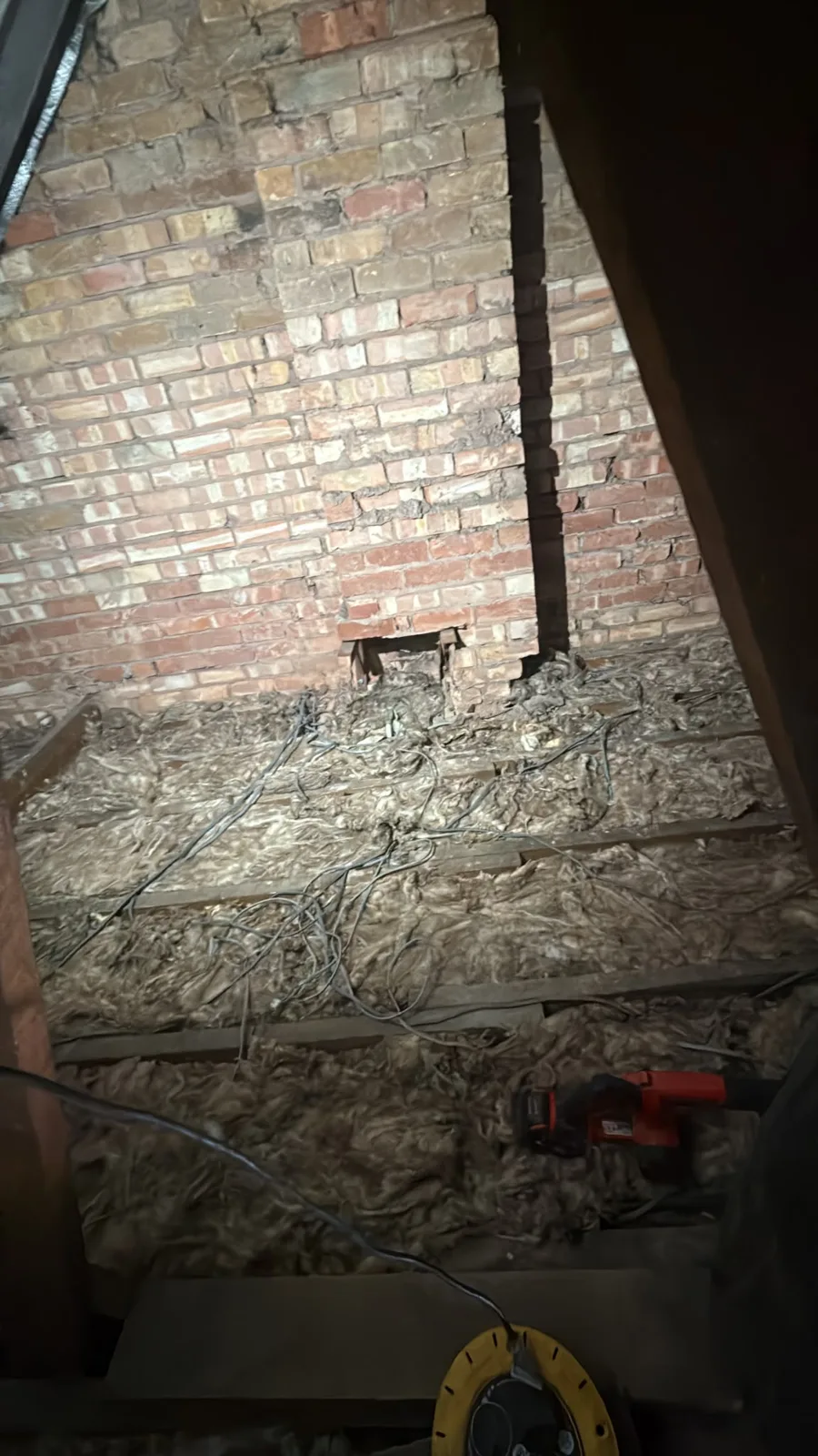 Old flattened fibreglass and cables between the joists of a Worksop loft before new loft insulation