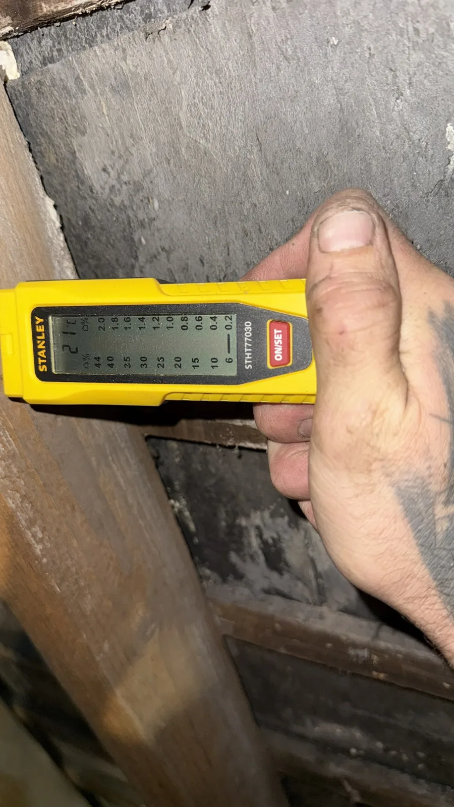 Moisture meter reading on a rafter after spray foam removal in Birmingham
