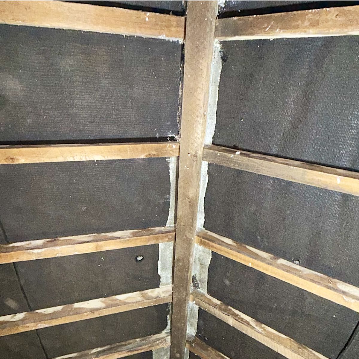 Loft rafters in Burnley cleared back to the bitumen felt after open cell spray foam removal