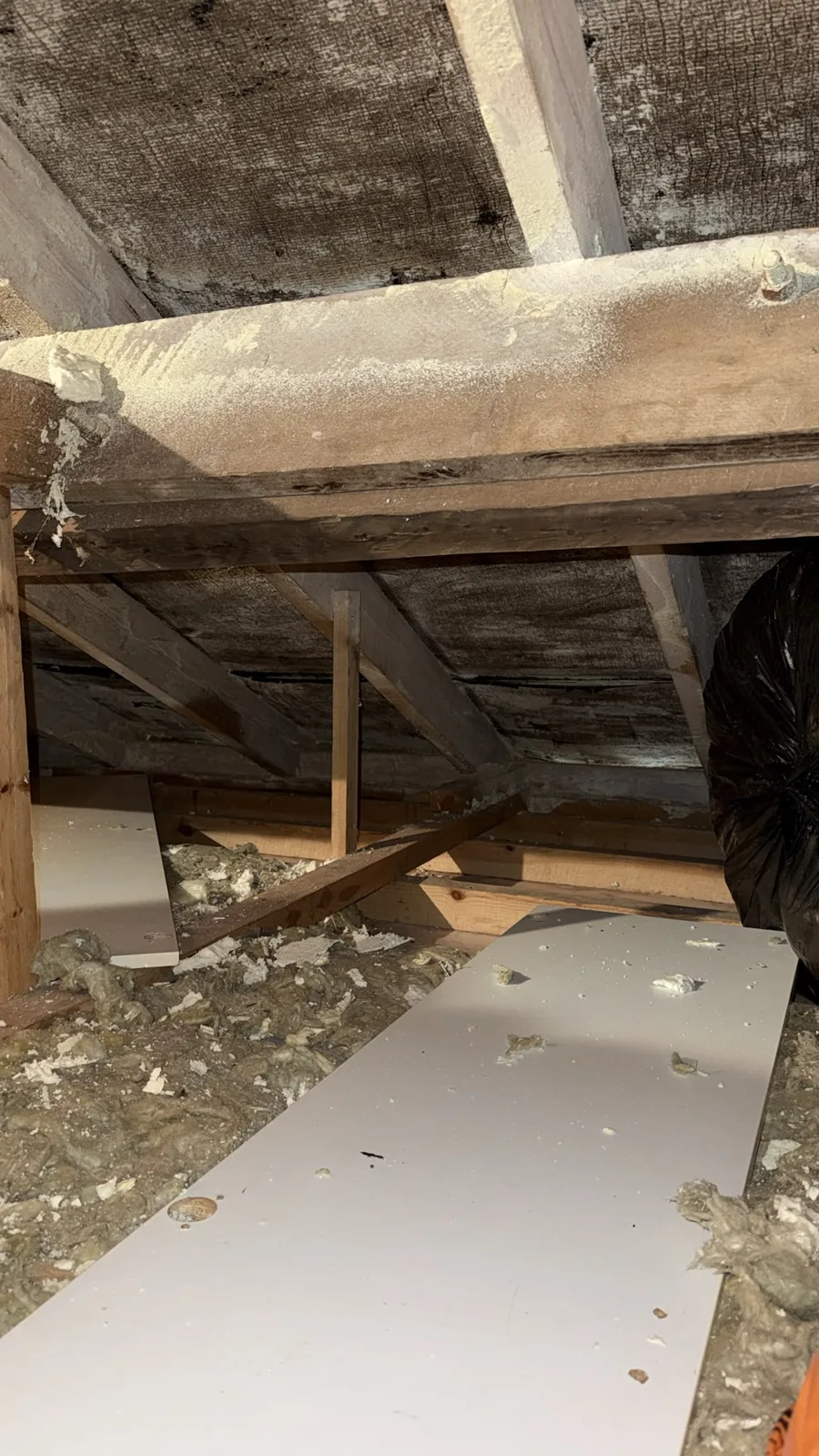 Spray foam removal in progress in a Chorley loft with foam debris on the floor