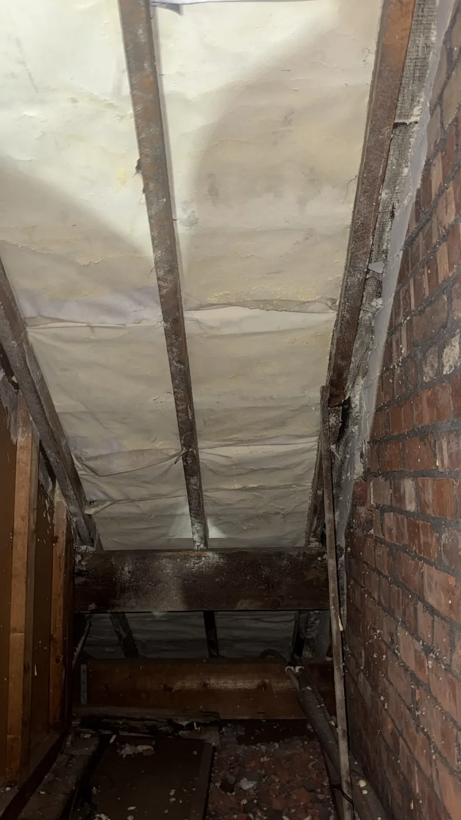 Rafter bays in an Oldham loft during open cell spray foam removal