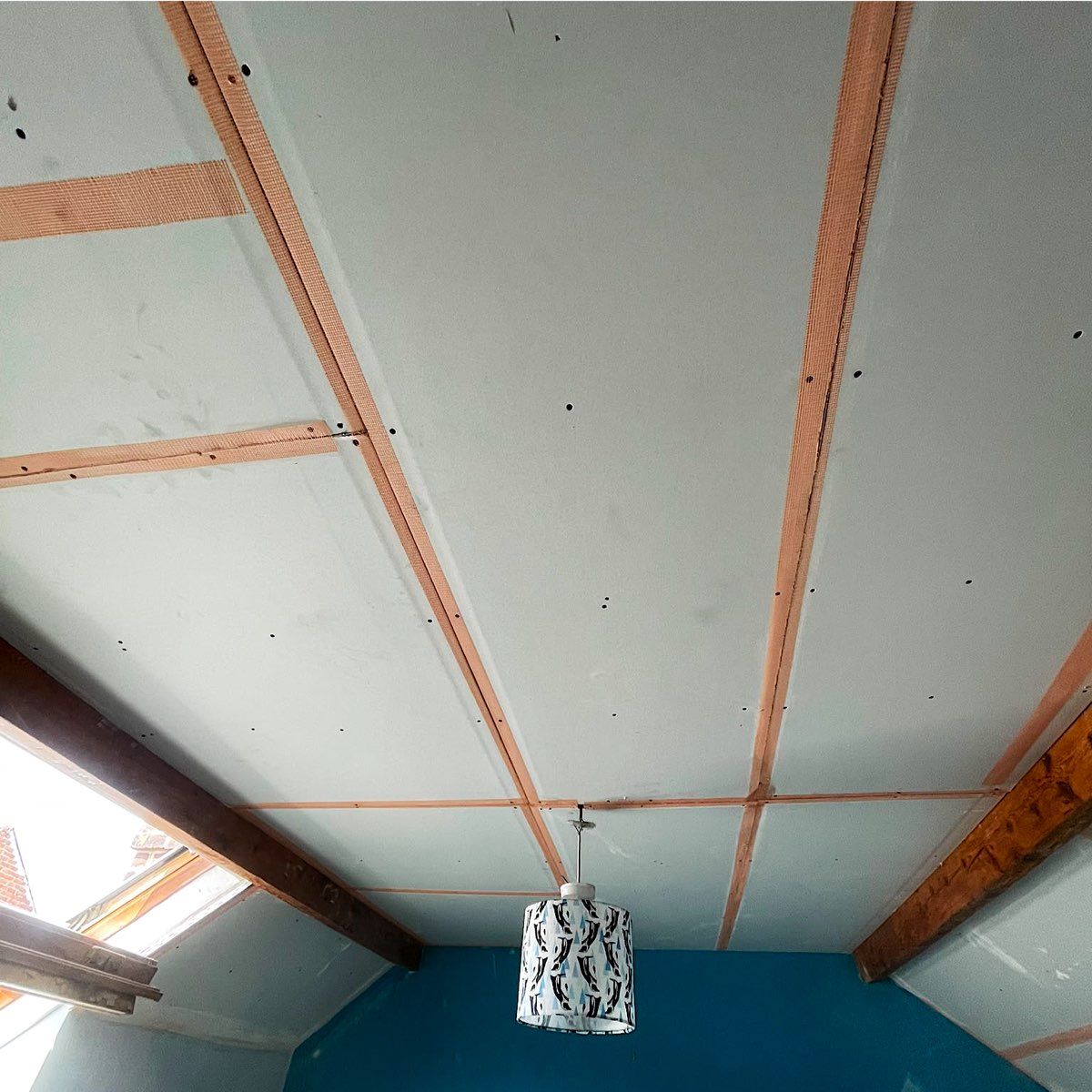 The Sheffield loft room ceiling lined with new plasterboard after the foam was removed
