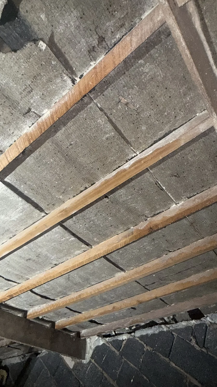Rafters and bitumen felt on show in a Shrewsbury loft after open cell spray foam removal