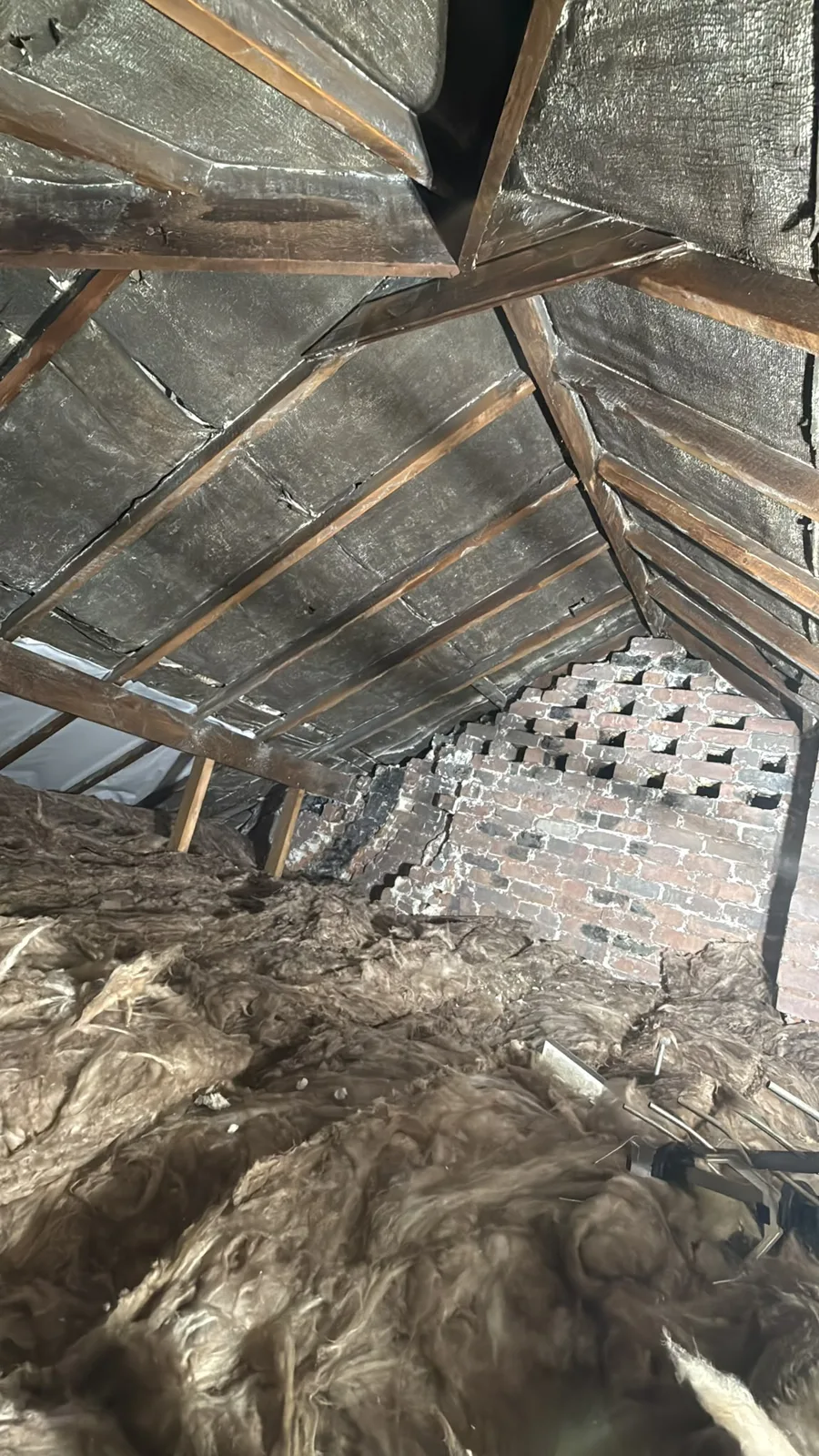 Wolverhampton loft after spray foam removal with the felt on show and mineral wool on the floor