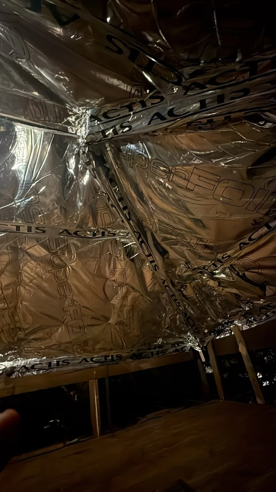 Taped SuperFOIL joints on the rafters in a Rusholme, Manchester loft
